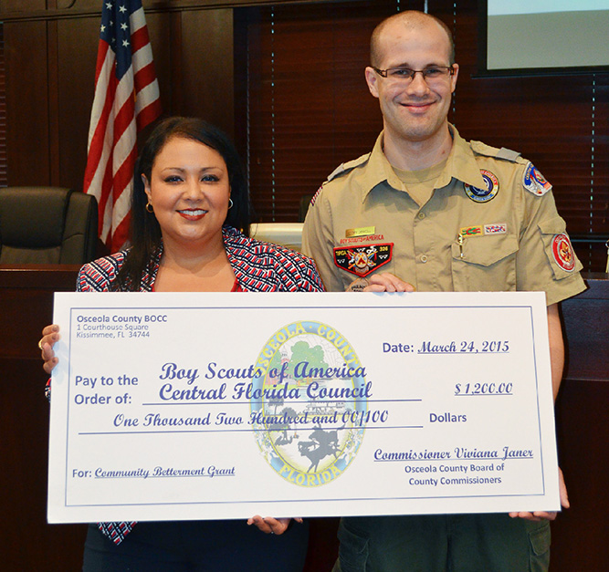 Commissioner Viviana Janer presents a check to Cory Dewell, District Executive of Osceola County (Central Florida Council Boy Scouts of America). 