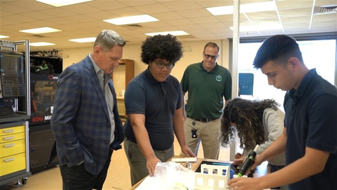 Vice Chairman & District 3 County Commissioner Brandon Arrington (L) looks on as students describe their work as part of the academy at Liberty High School. (PHOTO:  Reach)