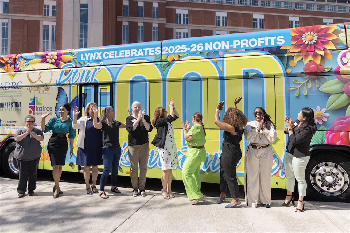 LYNX CEO Tiffany Holmer Hawkins and Osceola County Board of County Commissioners & LYNX Chairwoman Viviana Janer joined by non-profit leaders and workers celebrates as LYNX unveils its 2025-26 Public Service Bus in Osceola County.