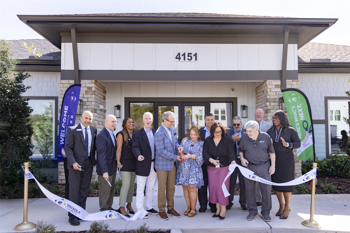 Chairwoman Viviana Janer (C) is joined by Bank of America Central Florida President, Naveed Shujaat (L); Birdsong Housing Partners CEO Steve Auger (2nd from L); Osceola County Housing & Community Services Director Danicka Ransom (3rd from L); Pinnacle Co-Founder & President David O. Deutch (4th from L); Pinnacle Partner Timothy P. Wheat (5th from L); City of Kissimmee Commissioner Noel Ortiz (6th from R); City of Kissimmee Mayor Jackie Espinosa (5th from R); State Representative District 46 Jose Alvarez (4th from R); Florida Housing Finance Corporation Board Member & Past Chairman Ron Lieberman (3rd from R); Kissimmee City Manager Mike Steigerwald (2nd from R); Kissimmee Deputy City Manager Desiree Matthews (R) at the Ribbon Cutting for the Pinnacle at the Wesleyan apartment complex.
