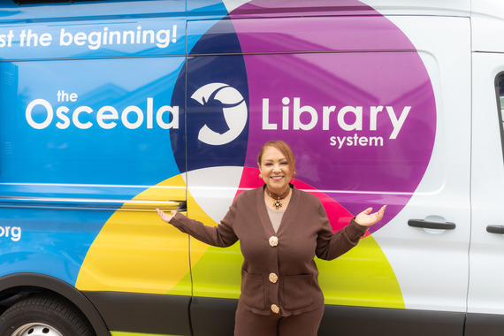 D2 Commissioner Viviana Janer stands in front of the Mobile Library Unit