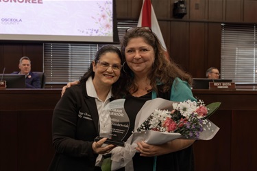 District 1 Commissioner Peggy Choudhry and Bettina Grzeskowiak at the Woman Warrior Ceremony.