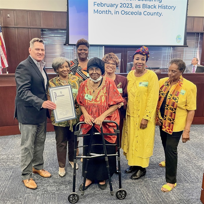 Chairwoman Viviana Janer and Dr. Johnson with award