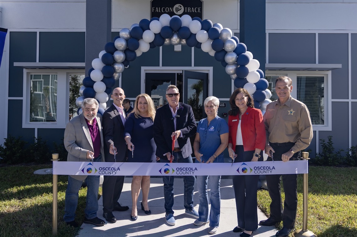 Osceola County Vice Chairman Brandon Arrington (C) is joined by Florida Housing Finance Corporation Board Member & Past Chairman Ron Lieberman (L); Birdsong Housing Partners CEO Steve Auger (2nd from L); JPMorgan Chase Community Development Banking Vice President Laura Myers (3rd from L); Osceola County Commissioner Cheryl Grieb (3rd from R); Bank of America Market Executive Senior Vice President Jodie Hardman (2nd from R); Osceola County Sherriff Chris Blackmon (R) at the Ribbon Cutting for the Falcon Trace II apartment complex.