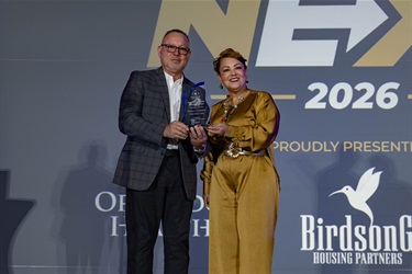 Commissioner Viviana Janer (D2), right, last year Board Chair, awards her Organization of the Year to Advanced Community Outreach Center and received by Norberto Fonseca, right