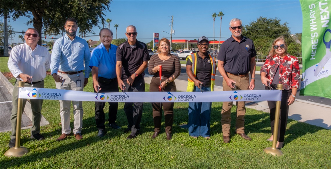 Commissioner Viviana Janer (D2), center, is joined by representatives of Jr. Davis, CONSOR, and Osceola County Chief Operating Officer Beth Knight, right.