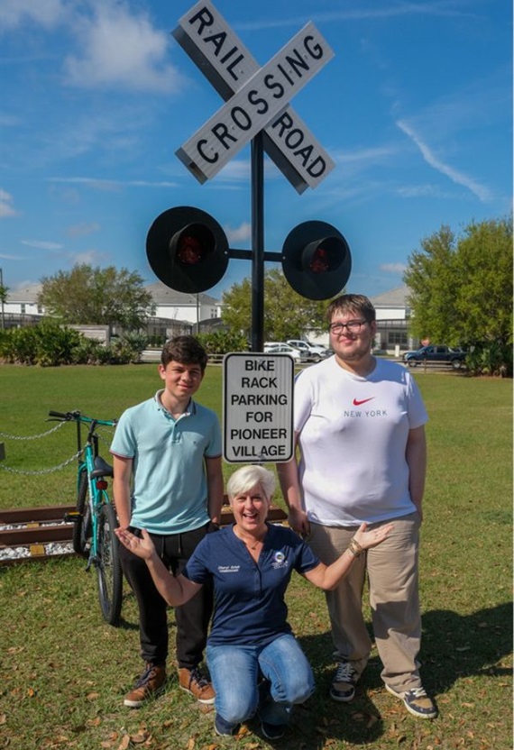Osceola Commission Chair Cheryl Grieb unveils a bike rack designed by two Zenith Accelerated Learning Academy students at Osceola's Pioneer Village on Friday.
