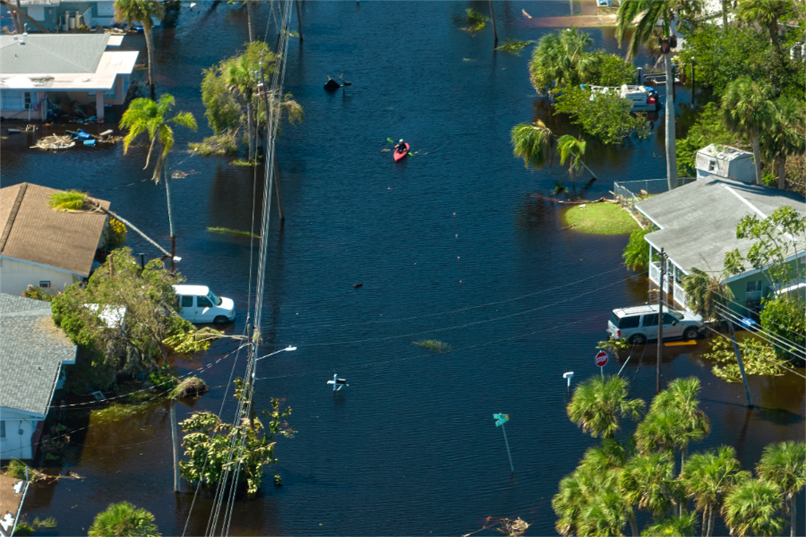 Kayaker in flooded streets.